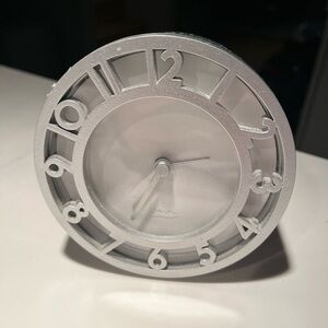 Michael graves alarm clock.  Measures approx 4.25” in diameter.